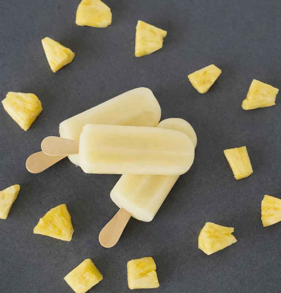 Pineapple fruit pops with scattered pineapple chunks